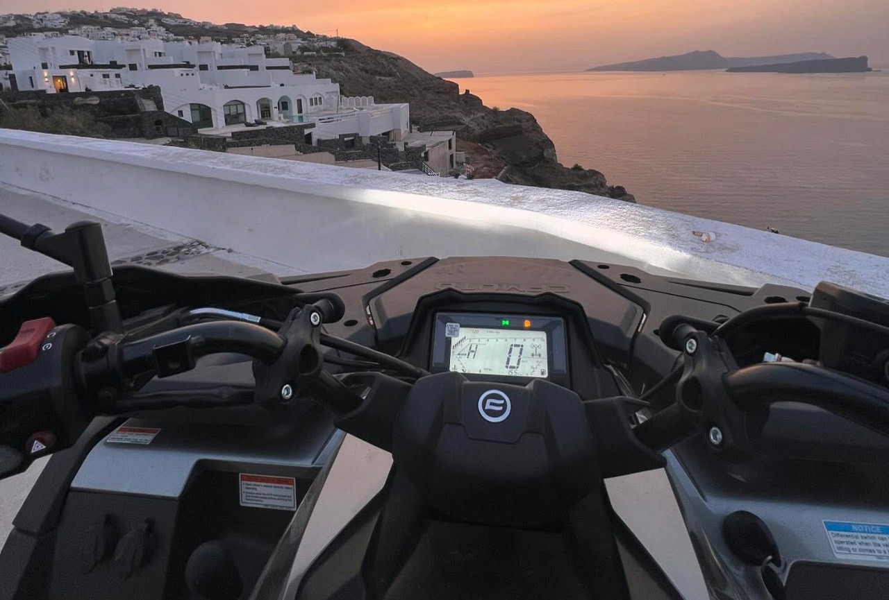 Couple on ATV tour near Santorini Red Beach cliffs